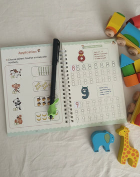 Review / Open copybook with educational content on a white surface with Montessori toys around